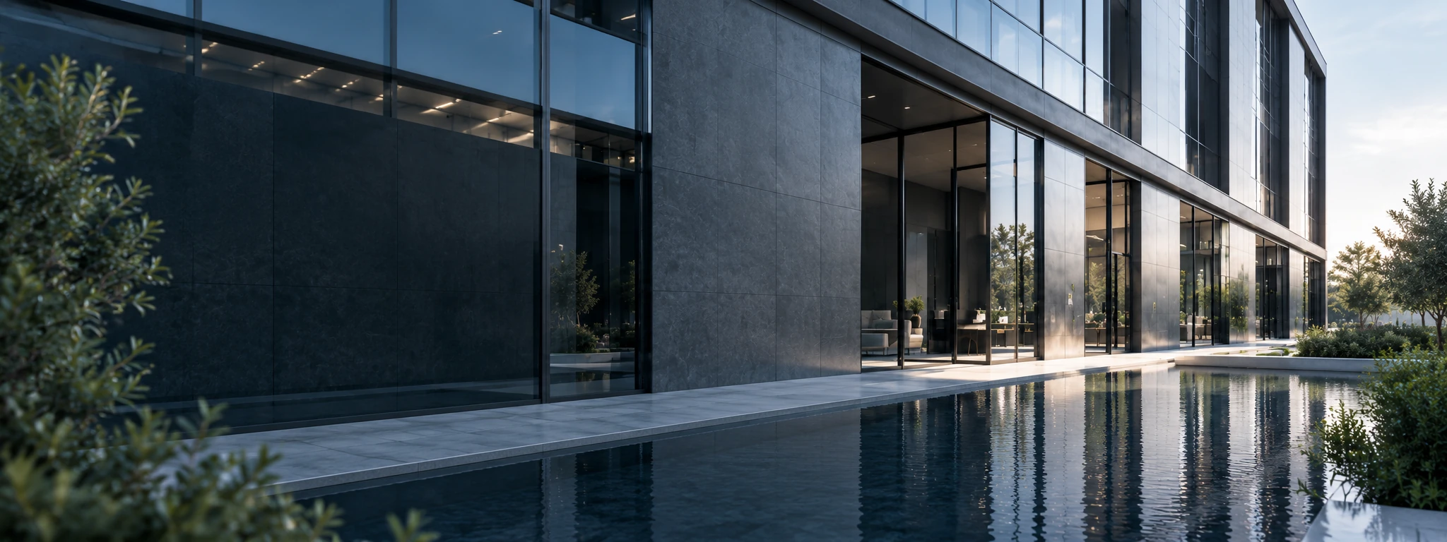 Matte black Hansberg faucet with running water over a dark stone basin